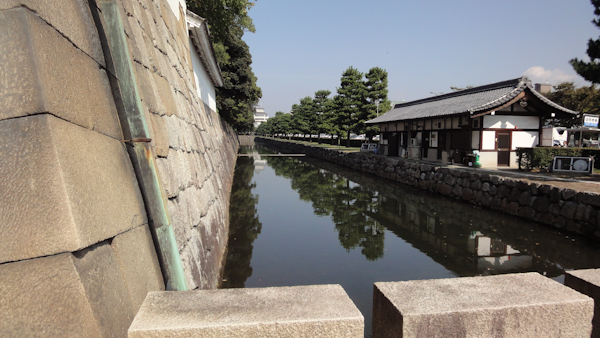 a carved stone wall and part of the moat
